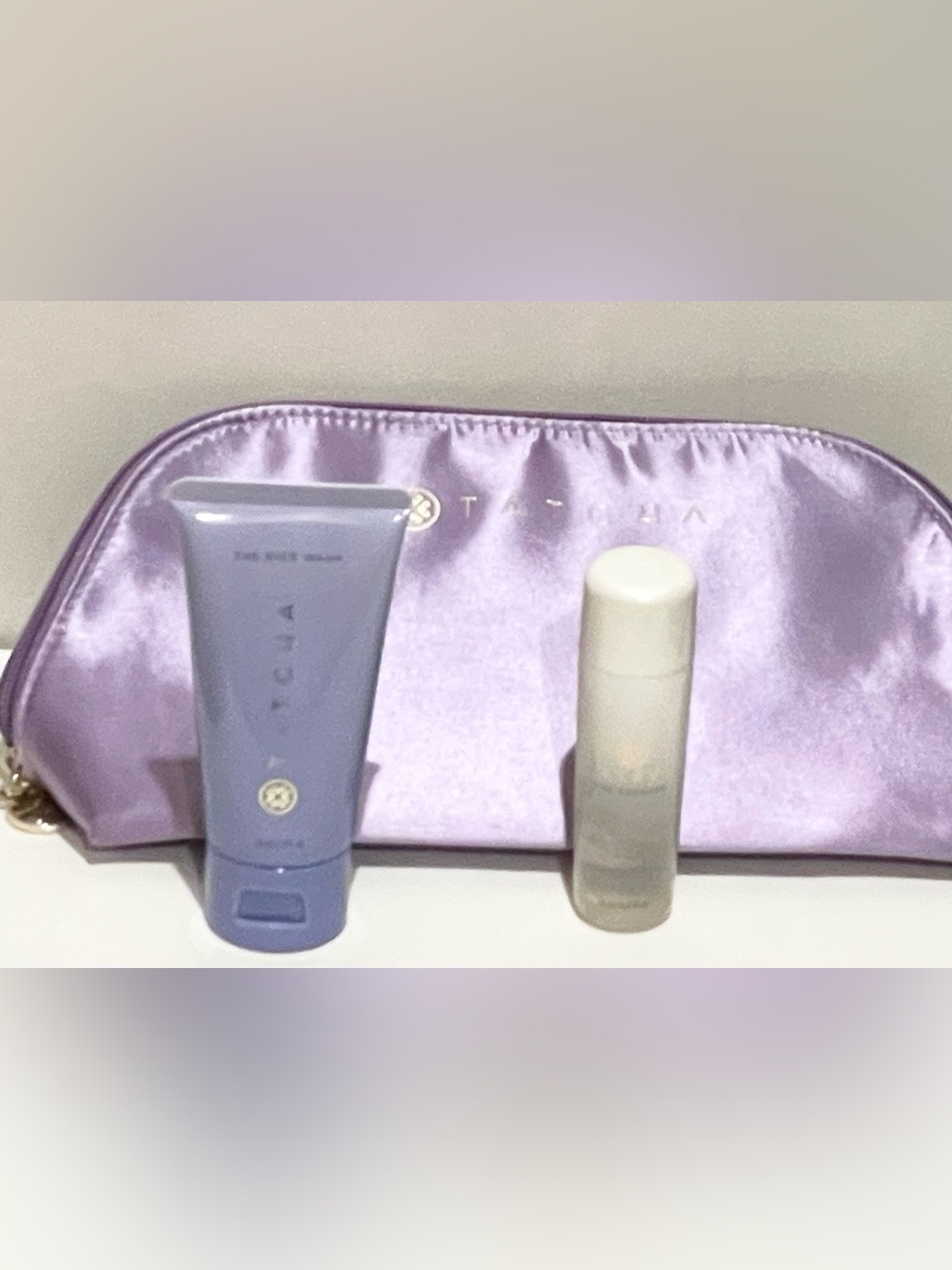 Tatcha 3-piece travel set: bag, the rice wash, and the essence.